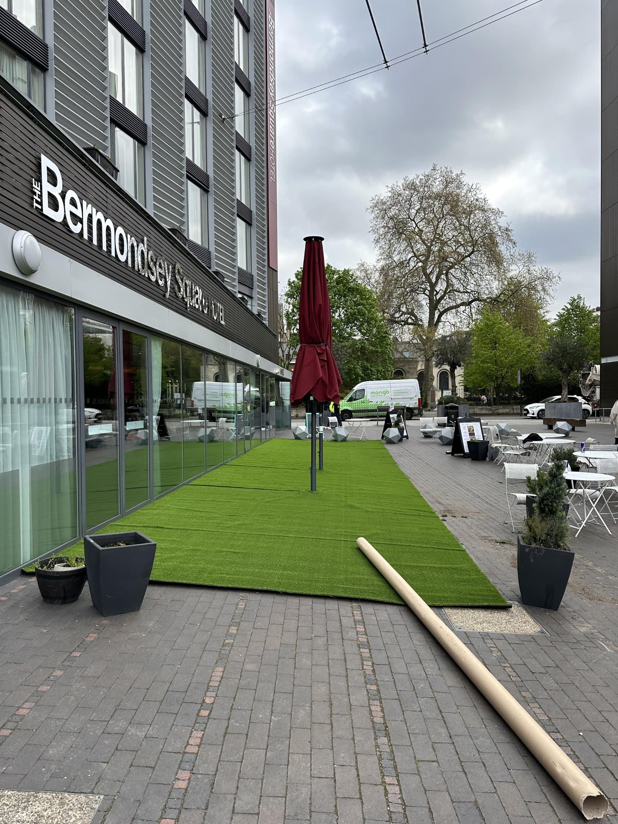 The artificial lawn being laid in place during the install