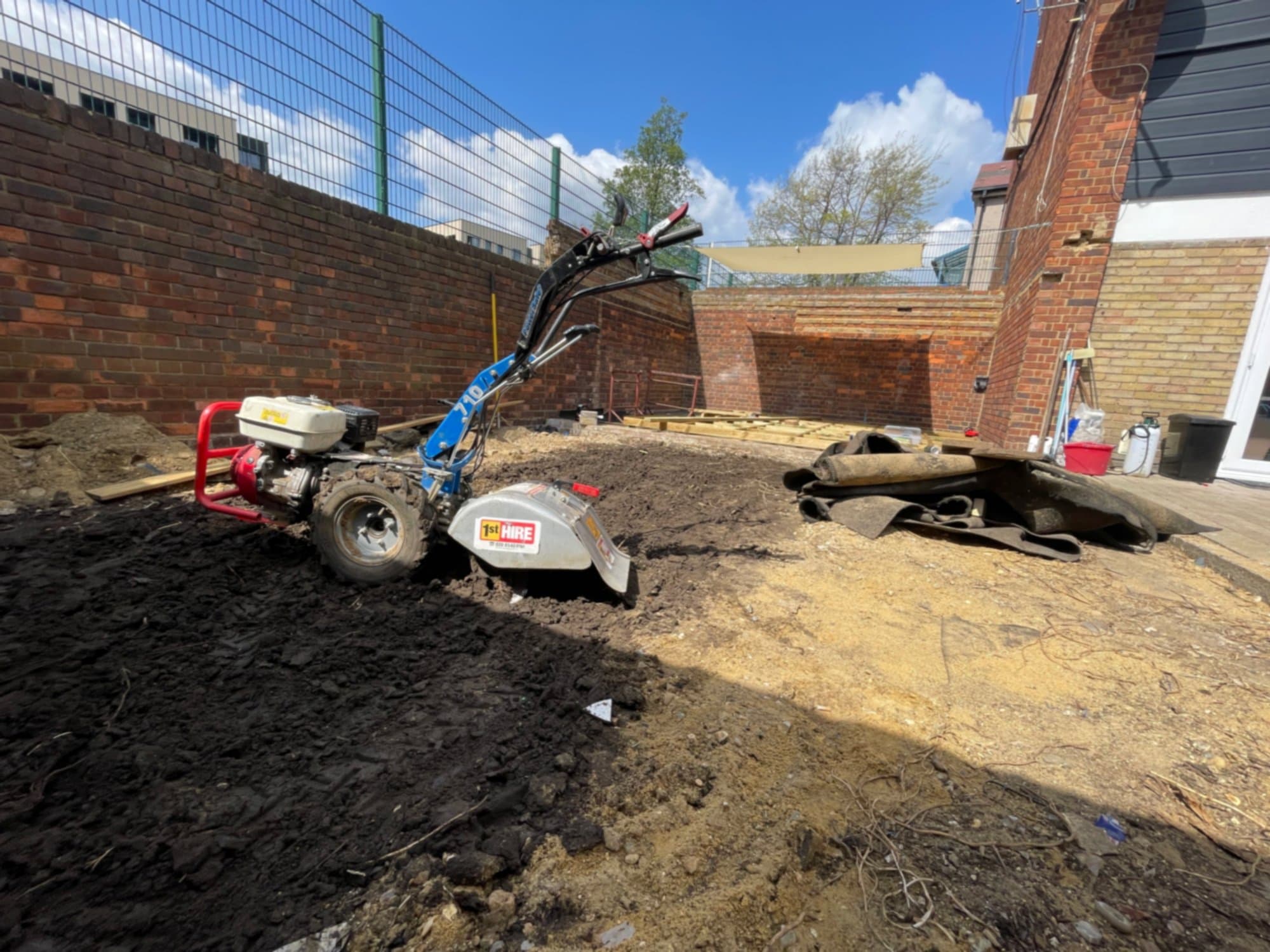 A small rotavator clearing the site down to bare ground before the substructure went in